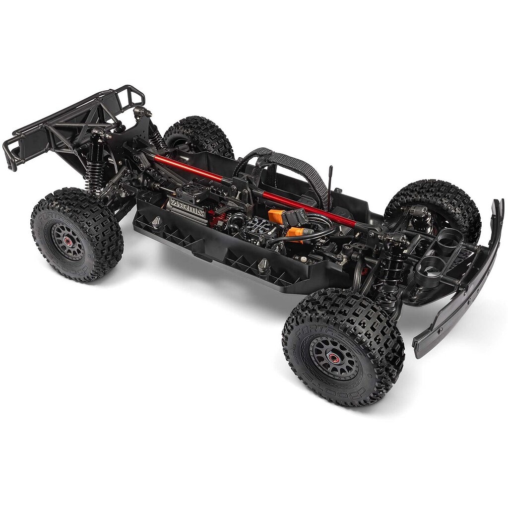 Detailed view of a remote control car chassis with large off-road tires and suspension system, ideal for RC racing enthusiasts.