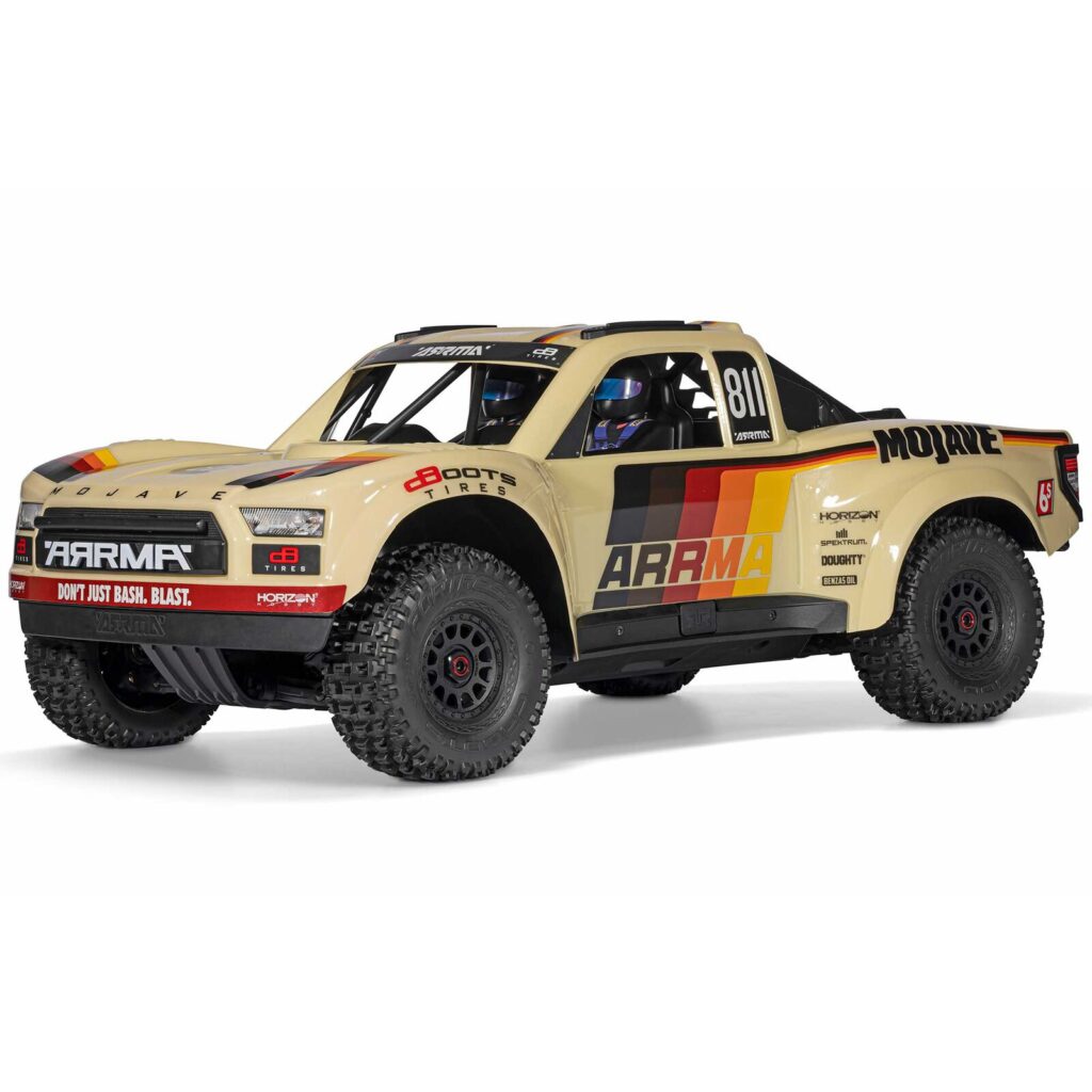 Detailed image of a beige RC off-road racing truck with sponsor decals and rugged tires, designed for RC enthusiasts and hobbyists.
