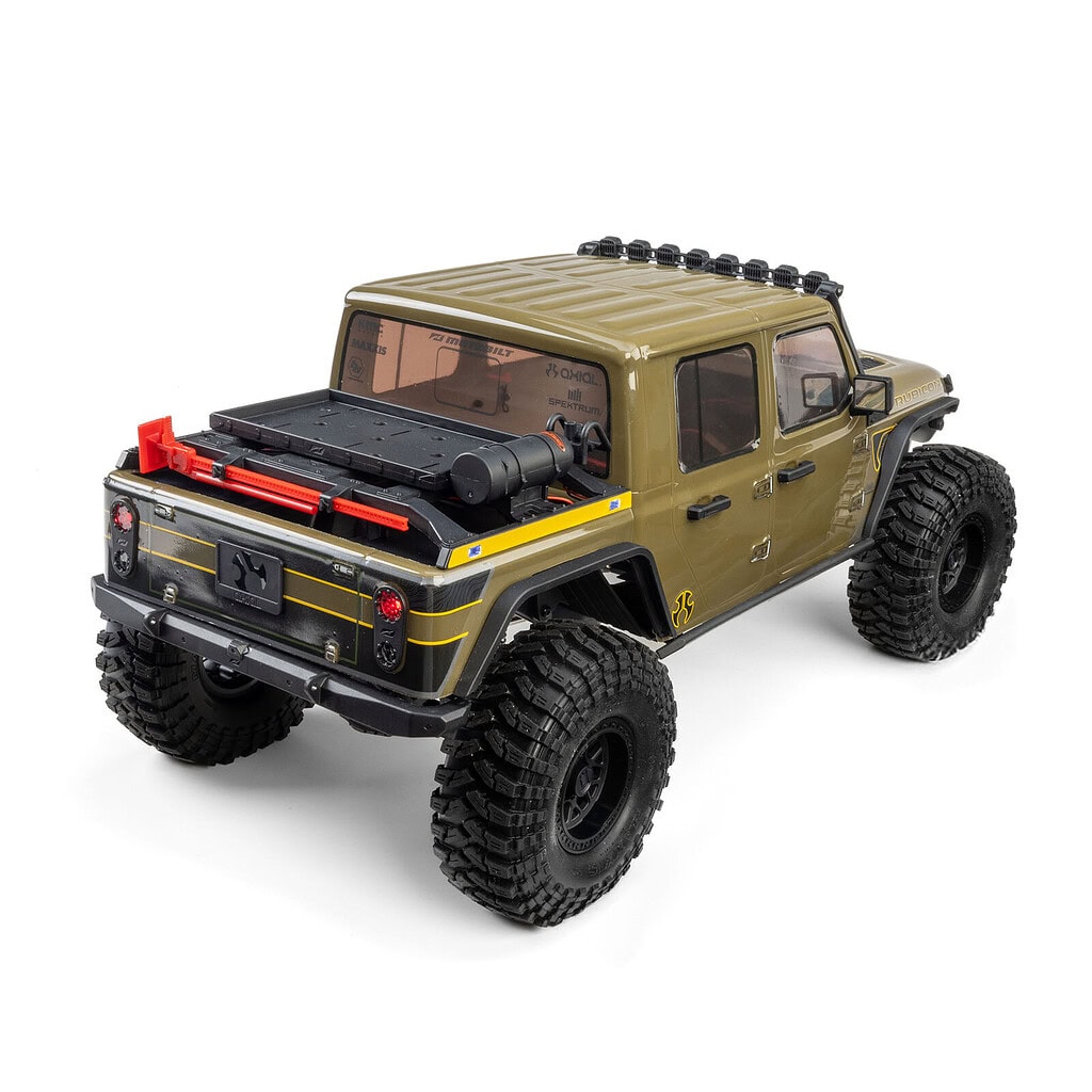 Detailed view of the RC Newb Axial SCX10 III Motobilt Waypoint Jeep JT Gladiator RTR with rugged tires and detailed exterior.