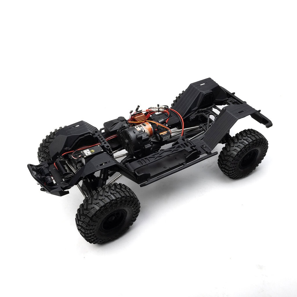 Detailed view of a remote control car chassis with electronic components and rugged tires, suitable for off-road RC adventures.