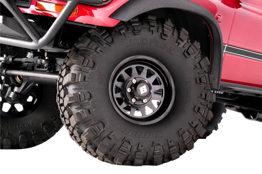 Close-up of a rugged off-road RC vehicle tire with deep treads for enhanced traction on rough terrains.