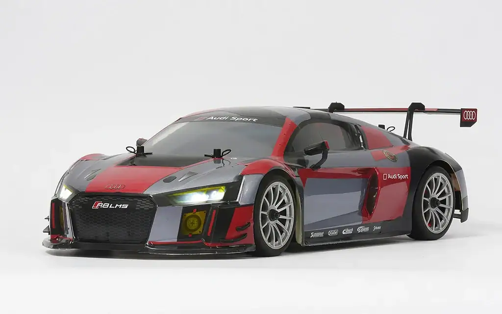 Detailed view of the RC Newb Audi R8 LMS race car with checkered flag branding and aerodynamic design, showcasing its racing features and sleek body.
