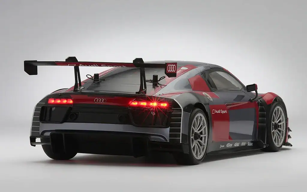 High-performance Audi R8 LMS race car with aerodynamic features and racing livery, positioned on a plain white background.