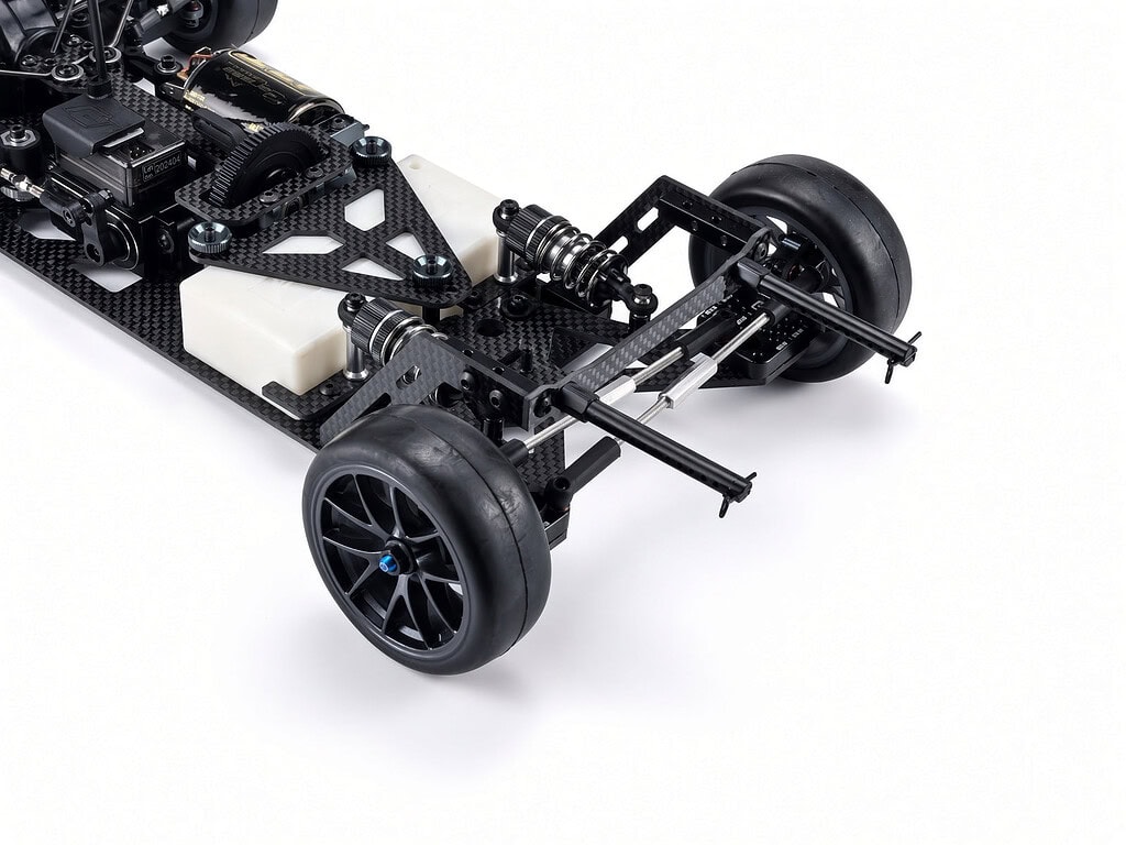 Close-up of the RC Carisma M40F FWD mid-motor on-road chassis kit showing detailed suspension and wheel setup.