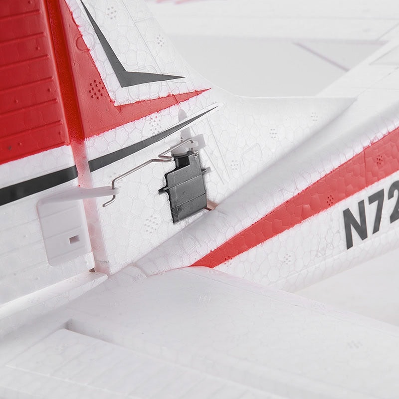 Close-up of a remote control model airplane’s nose, featuring a detailed hatch latch and red and white wing and fuselage decals, perfect for RC hobbyists and drone enthusiasts.