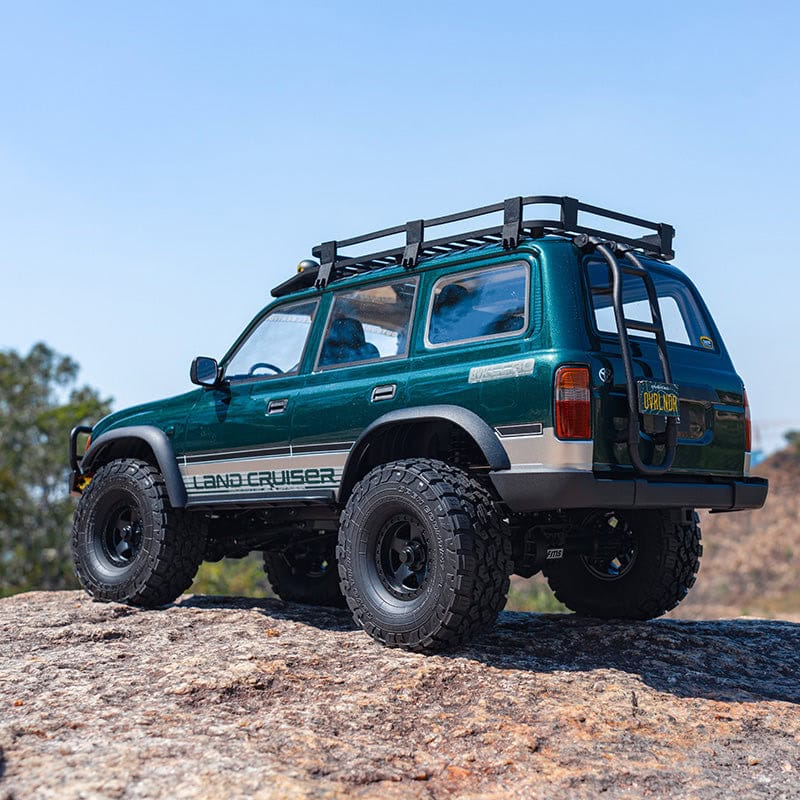 RC Land Cruiser 80 with brushless motor, off-road tires, and roof rack for rugged terrain.