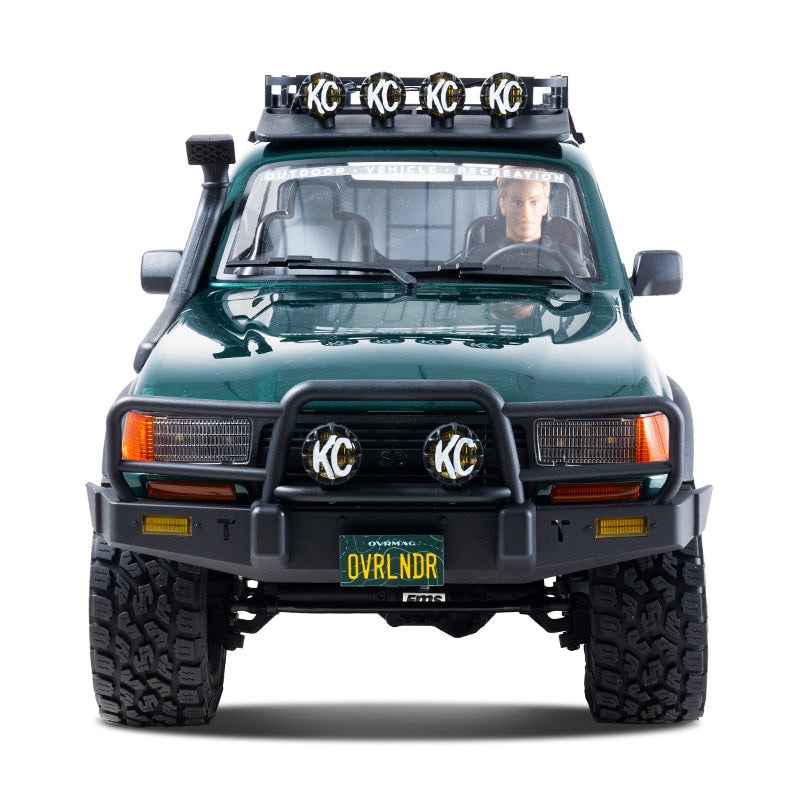 Detailed RC model of a Toyota Land Cruiser 80 with off-road accessories, including roof lights and custom license plate, perfect for RC enthusiasts and collectors.