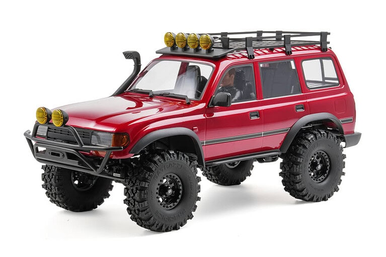A detailed image of a red RC off-road vehicle equipped with a roof rack and multiple auxiliary lights, designed for rugged terrain and outdoor adventures.