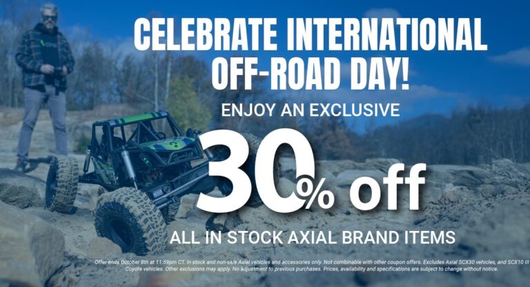 RC off-road vehicle with large tires navigating rocky terrain during daytime promotional event | Celebrate International Off-Road Day with 30% off all in stock Axial brand RC vehicles and accessories | The image features a remote-controlled off-road vehicle tackling rugged terrain, promoting a sale for enthusiasts celebrating off-road adventure. It highlights the excitement of RC off-road driving, showcasing high-performance Axial models perfect for hobbyists seeking quality RC vehicles, accessories, and off-road fun. | Relevance: Highly relevant for RC hobbyists, off-road enthusiasts, and customers interested in remote-controlled vehicles and accessories, aligned with the promotional event and target audience.