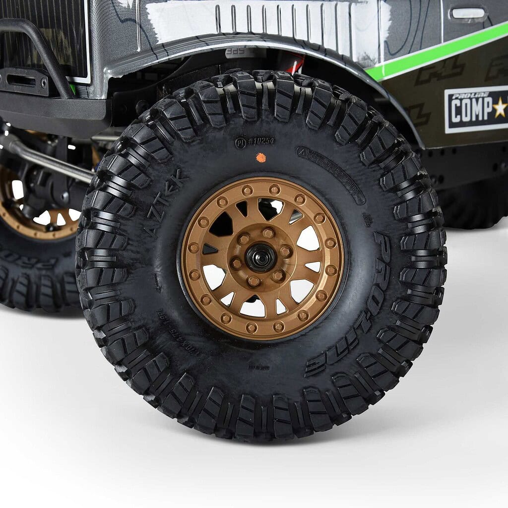 Off-road RC car tire with rugged black tread and gold alloy wheel, designed for durability and performance in rc rock crawling and off-road adventures.