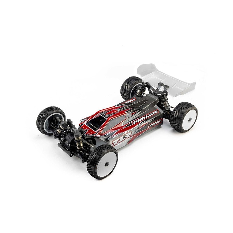 High-performance RC car with a sleek red and black design, durable tires, and advanced suspension system for off-road and on-road racing. Perfect for RC hobbyists and competitive racing.
