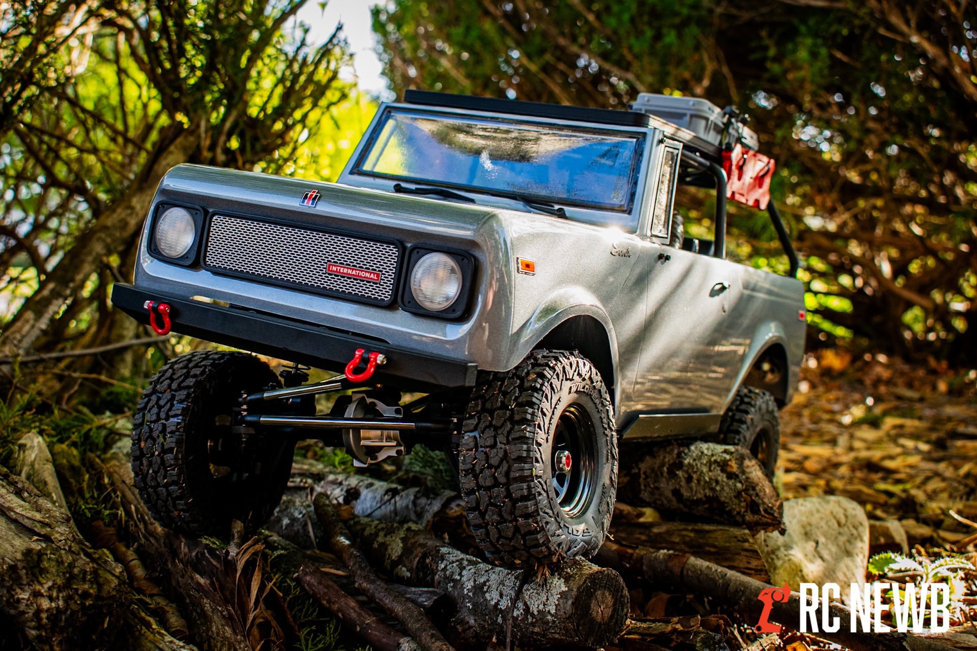 Off-road remote control truck driving on forest terrain with detailed tires and realistic design, showcasing RC vehicle customization and outdoor RC adventures.