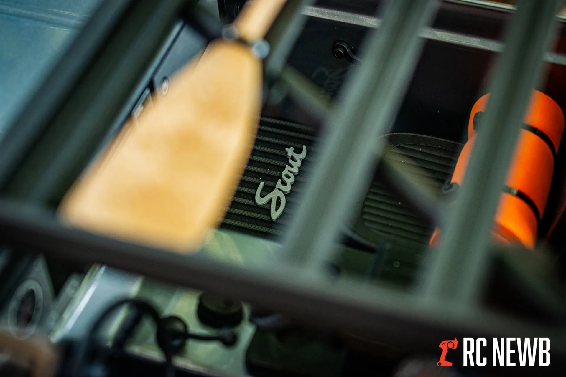 RC car engine inside chassis with "Scout" branding, showcasing detailed internal components and cooling system. Perfect for remote control car enthusiasts and hobbyists.
