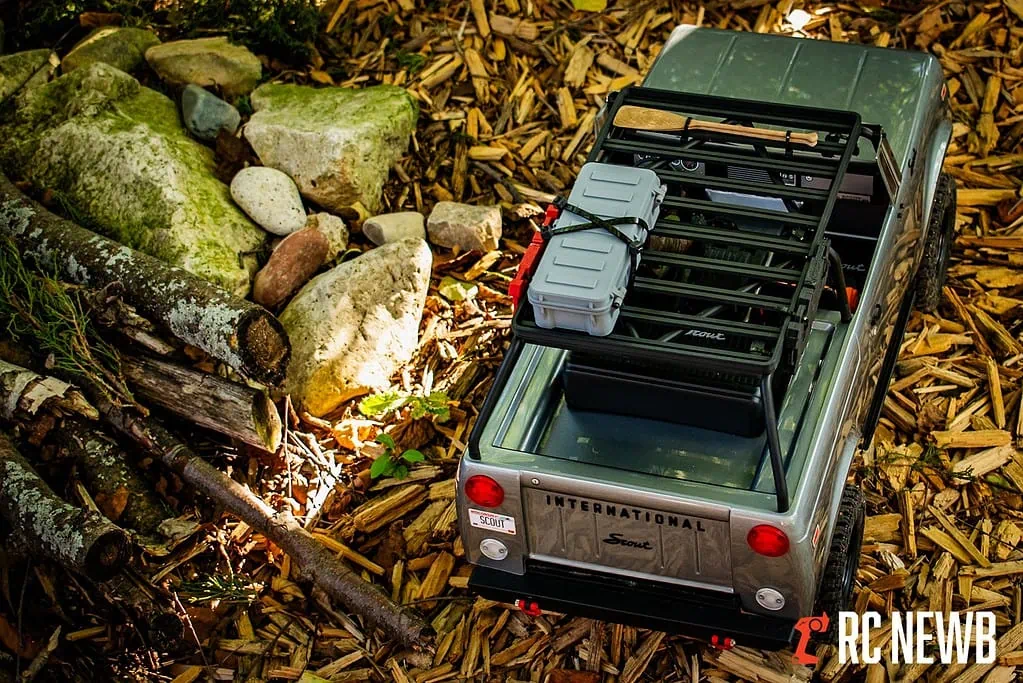 RC truck loaded with equipment on a woodchip trail in a forest, focusing on off-road RC vehicle handling and outdoor RC adventures.