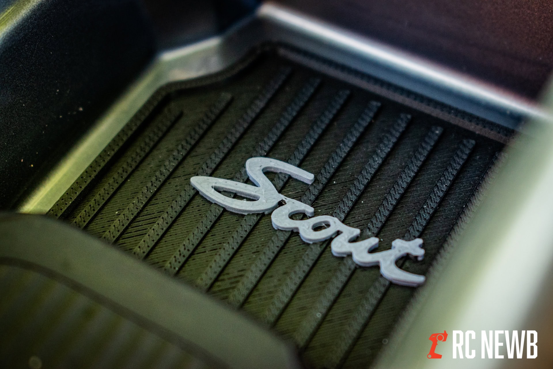 Shure logo on a black textured surface, close-up of the reputable audio equipment brand's emblem for RC hobbyists and RC enthusiasts.