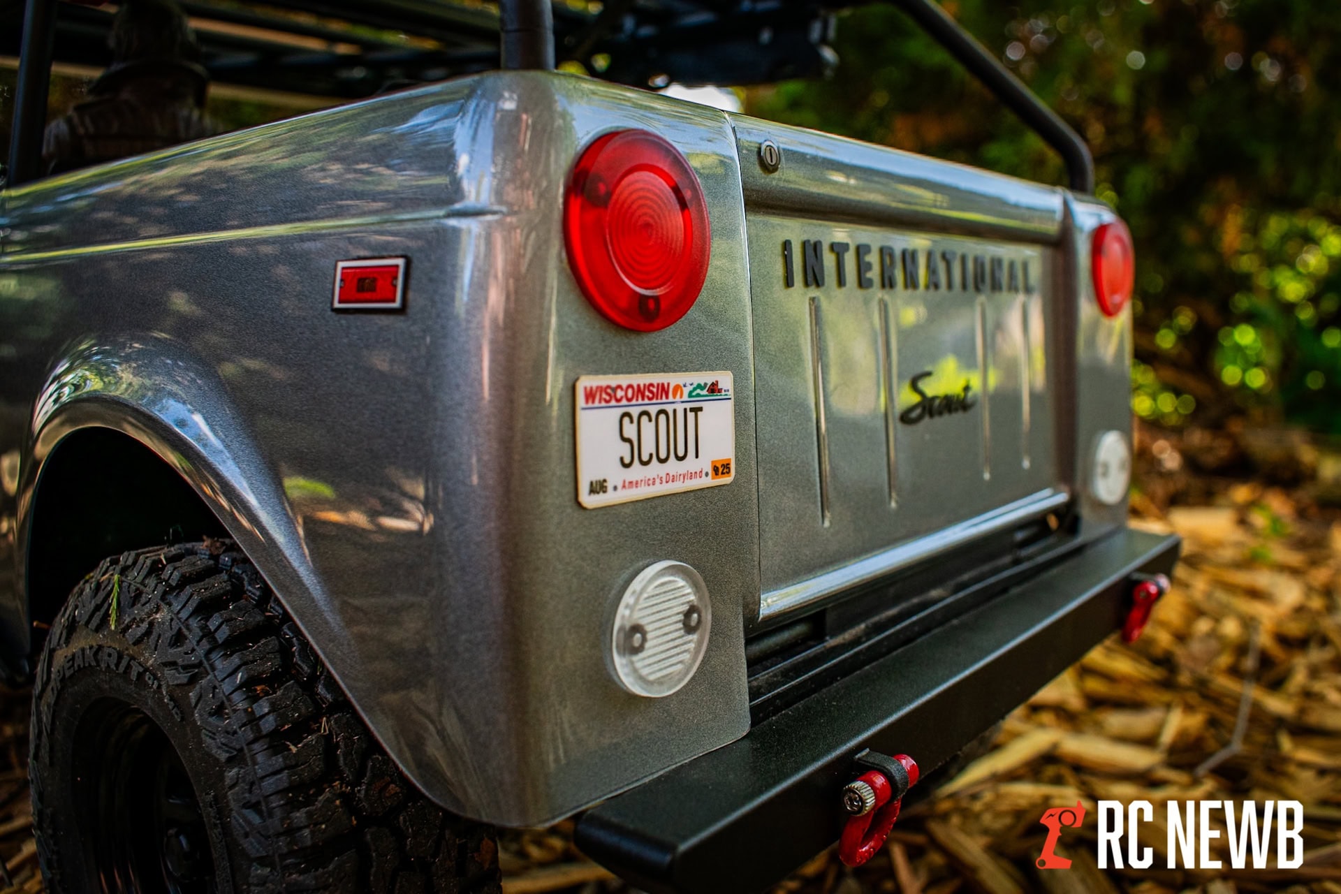 Heavy-duty RC toy truck with rugged tires and vintage license plate, perfect for off-road adventures, displayed outdoors among autumn leaves.