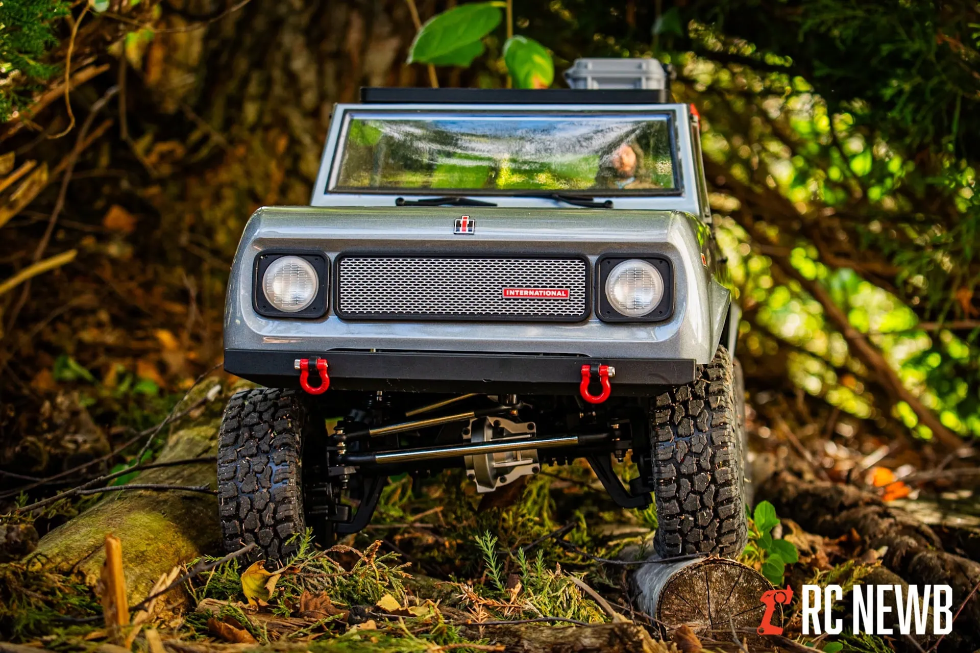Off-road RC truck navigating a forest trail on uneven terrain, showcasing rugged tires and suspension system for outdoor RC adventures.