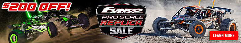 RC car racing on rugged terrain with vibrant green and black vehicle.