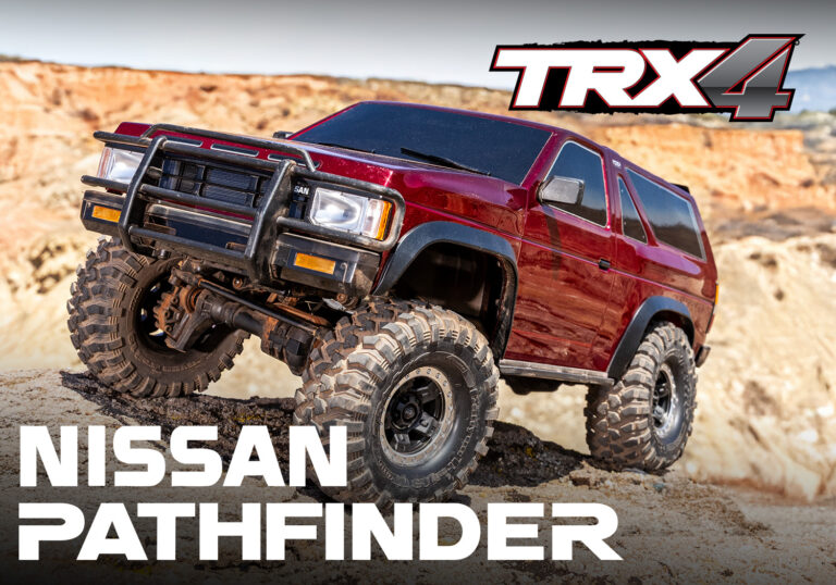 Nissan Pathfinder RC off-road vehicle on rugged terrain with large tires and protective front grille.
