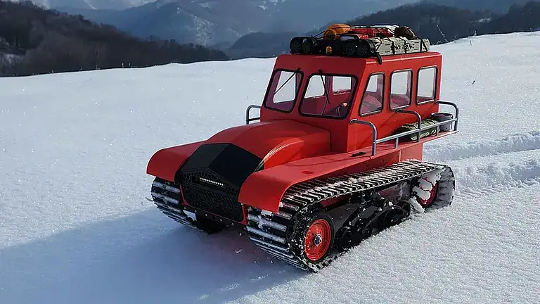 Detailed 3D-printed remote-controlled snowcat with realistic tracks and rugged design, perfect for winter outdoor adventures and hobbyists.